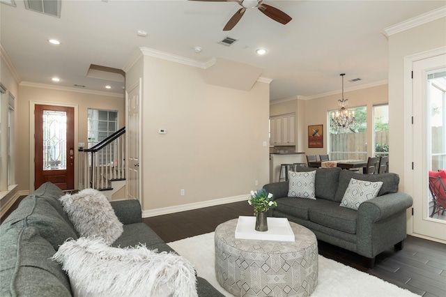 living area featuring visible vents, dark wood-style floors, stairway, and ceiling fan with notable chandelier