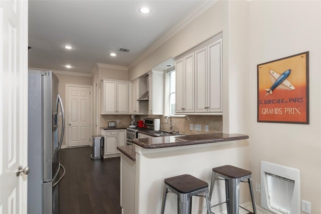 1900 Vermont St Unit B, Houston, TX 77019 - kitchen with appliances with stainless steel finishes, a peninsula, ornamental molding, dark countertops, and tasteful backsplash