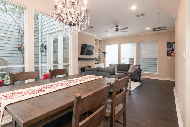dining area with ornamental molding, ceiling fan with notable chandelier, baseboards, visible vents, and dark wood-style floors