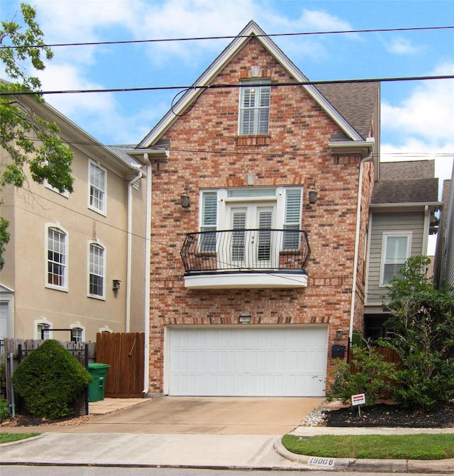view of front facade with brick siding, driveway, a balcony, and a garage
