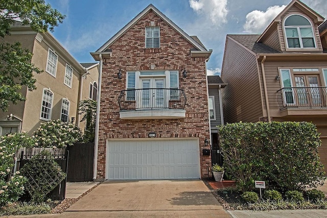 1900 Vermont St Unit B, Houston, TX 77019 - view of front of home with a balcony, brick siding, driveway, a garage, and french doors