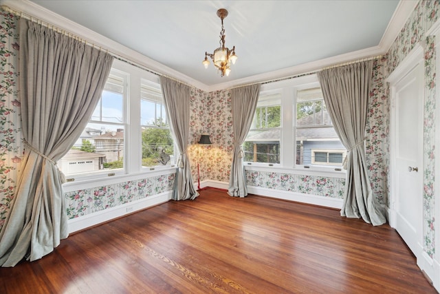 2614 Stanford St, Houston, TX 77006 - empty room with wallpapered walls, baseboards, wood finished floors, a chandelier, and crown molding