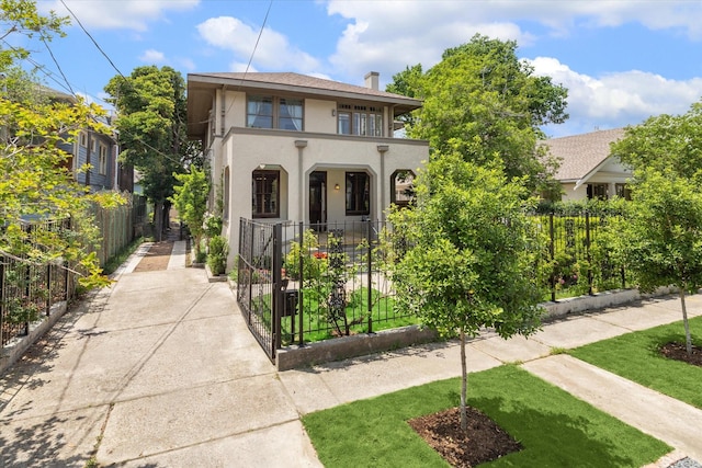 2614 Stanford St, Houston, TX 77006 - view of front of home with stucco siding and a chimney