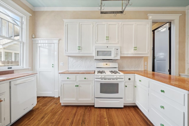 2614 Stanford St, Houston, TX 77006 - kitchen with white appliances, light countertops, wood finished floors, white cabinetry, and ornamental molding