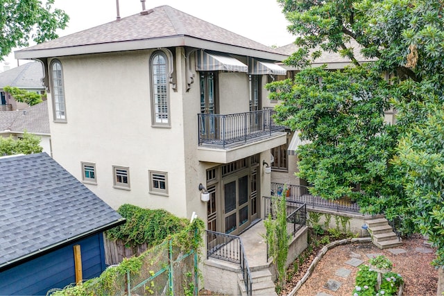 2614 Stanford St, Houston, TX 77006 - back of house with a balcony, roof with shingles, stairs, and stucco siding