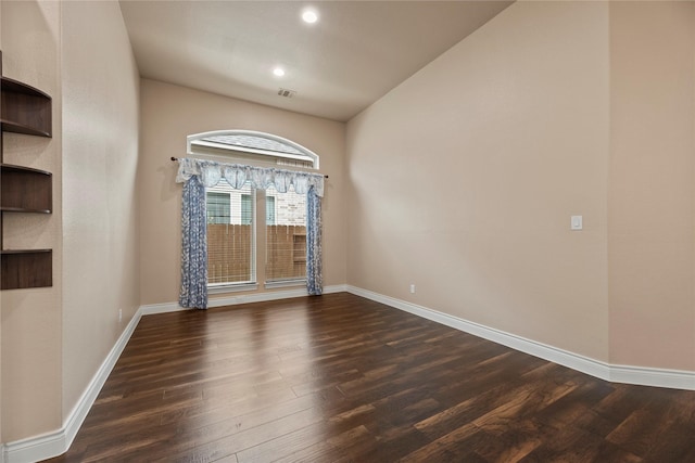 15306 Guava Vis, Conroe, TX 77302 - spare room with dark wood-type flooring, baseboards, lofted ceiling, and recessed lighting