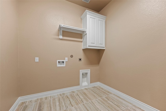 15306 Guava Vis, Conroe, TX 77302 - laundry area featuring hookup for an electric dryer, washer hookup, cabinet space, and baseboards