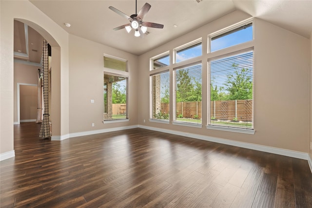 15306 Guava Vis, Conroe, TX 77302 - unfurnished room featuring healthy amount of natural light, dark wood-style floors, a ceiling fan, baseboards, and vaulted ceiling