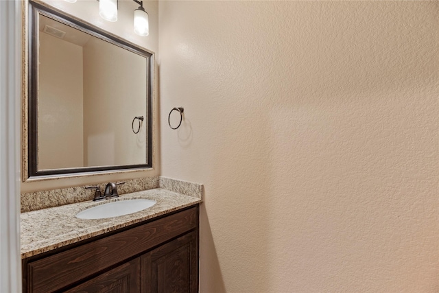 15306 Guava Vis, Conroe, TX 77302 - bathroom with vanity and a textured wall