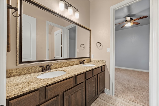15306 Guava Vis, Conroe, TX 77302 - full bathroom with double vanity, a ceiling fan, and baseboards