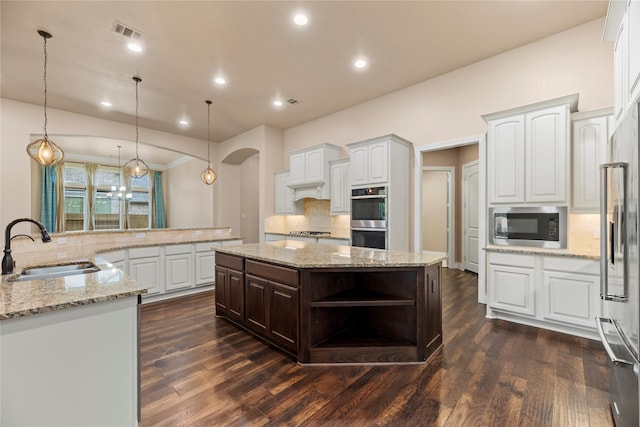 15306 Guava Vis, Conroe, TX 77302 - kitchen with a sink, appliances with stainless steel finishes, a large island, backsplash, and recessed lighting