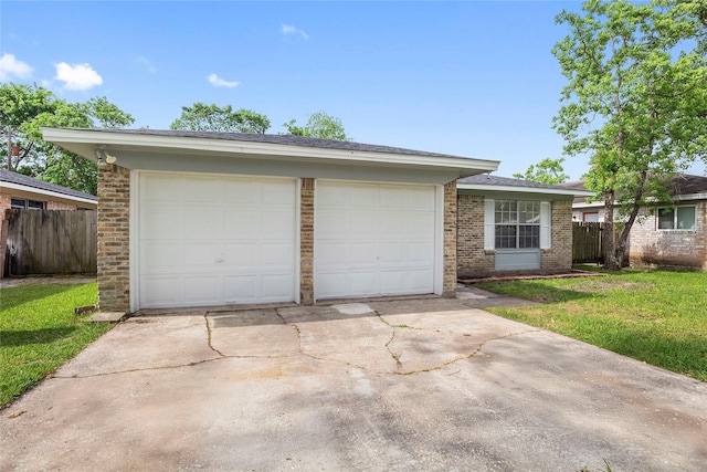 ranch-style home featuring fence, driveway, a front lawn, and brick siding