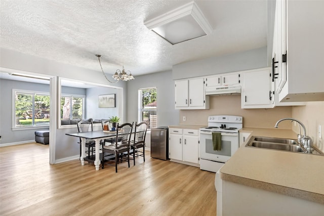 kitchen with electric range, light countertops, under cabinet range hood, a sink, and light wood-style flooring