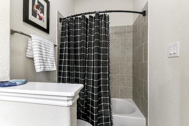 2502 Crossvine Dr, Katy, TX 77494 - bathroom featuring a textured wall and shower / bathtub combination with curtain