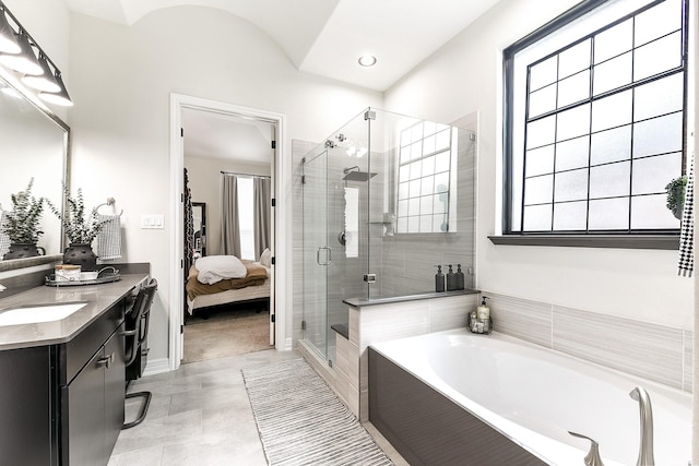 2502 Crossvine Dr, Katy, TX 77494 - bathroom with connected bathroom, vanity, baseboards, a bath, and a stall shower