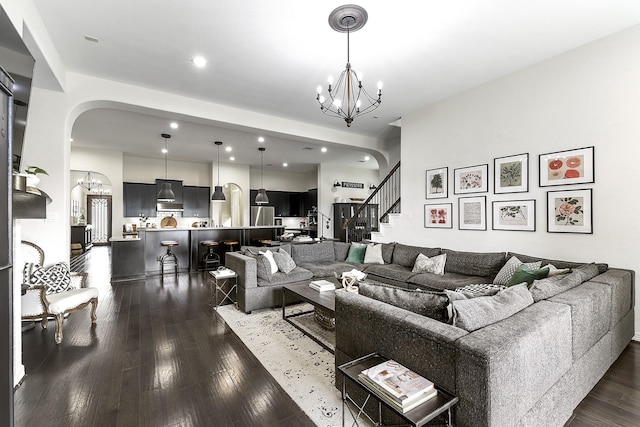 2502 Crossvine Dr, Katy, TX 77494 - living area with an inviting chandelier, stairway, dark wood-type flooring, recessed lighting, and arched walkways