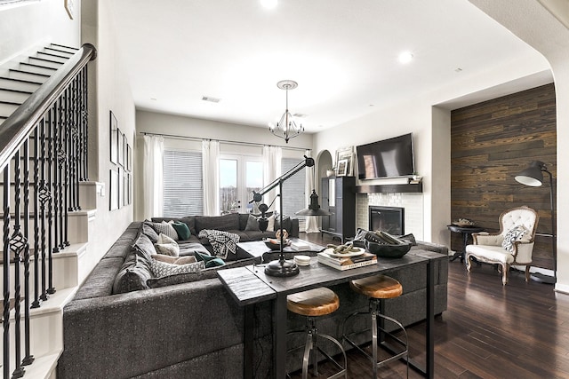2502 Crossvine Dr, Katy, TX 77494 - living room featuring dark wood-style flooring, a glass covered fireplace, stairway, recessed lighting, and a chandelier