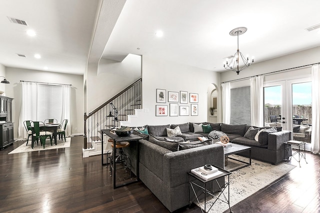 2502 Crossvine Dr, Katy, TX 77494 - living area with a chandelier, arched walkways, visible vents, and dark wood-type flooring
