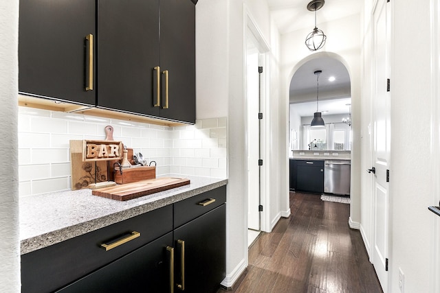 2502 Crossvine Dr, Katy, TX 77494 - bar with dark wood-style flooring, pendant lighting, arched walkways, tasteful backsplash, and dishwasher