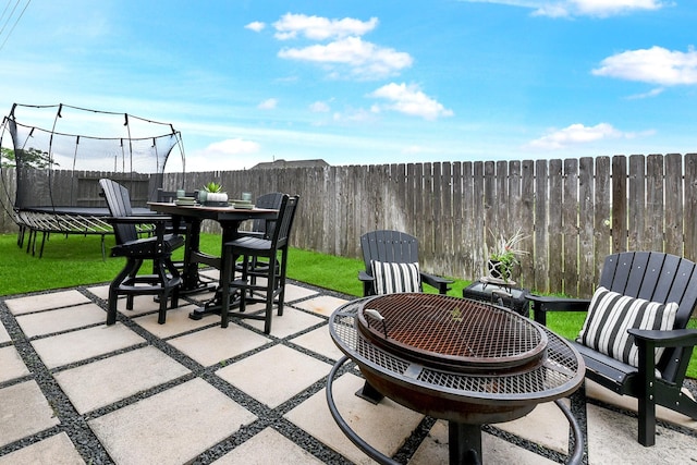 2502 Crossvine Dr, Katy, TX 77494 - view of patio with outdoor dining area, a fenced backyard, and a trampoline