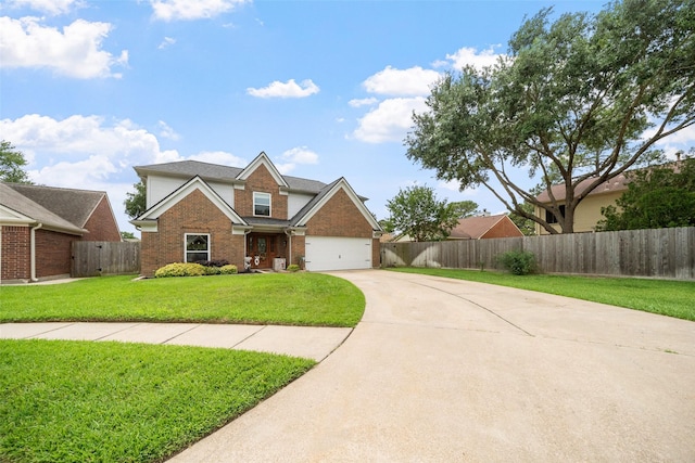 traditional home featuring driveway, a front yard, a garage, brick siding, and fence