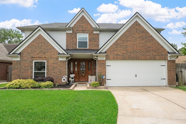 view of front of home featuring brick siding, roof with shingles, a front yard, and concrete driveway