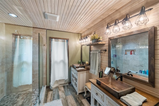 full bath with wood finished floors, a stall shower, wooden ceiling, and vanity