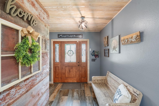 entryway featuring wooden ceiling, baseboards, and wood finished floors