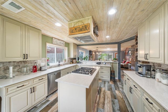 kitchen with visible vents, a peninsula, wood finished floors, wooden ceiling, and appliances with stainless steel finishes