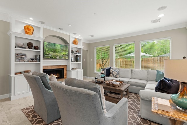 living room with visible vents, crown molding, plenty of natural light, and a fireplace