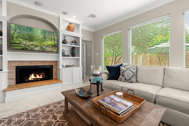 tiled living area featuring ornamental molding, a warm lit fireplace, and visible vents
