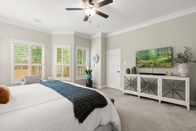 carpeted bedroom with baseboards, visible vents, ornamental molding, and ceiling fan