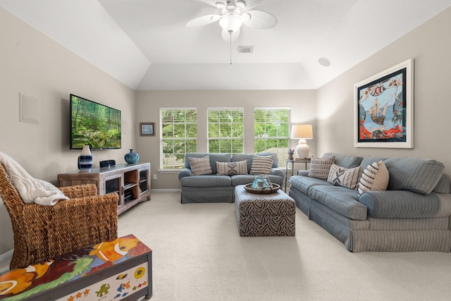 living area with ceiling fan, visible vents, vaulted ceiling, baseboards, and light carpet