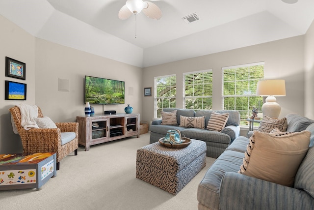 carpeted living room with ceiling fan, visible vents, and lofted ceiling