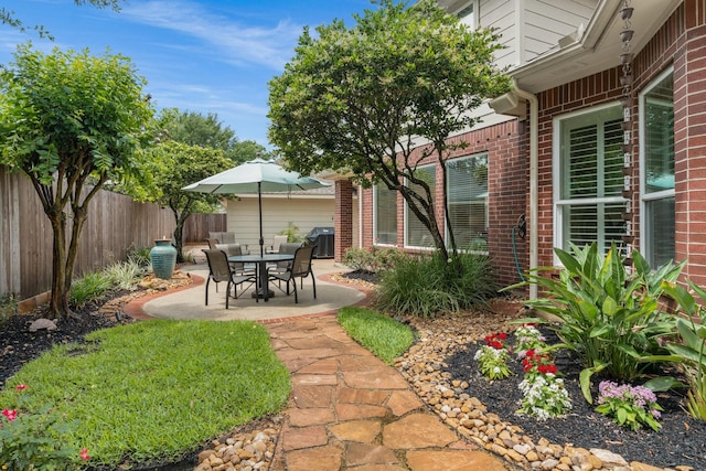view of yard featuring fence and a patio area