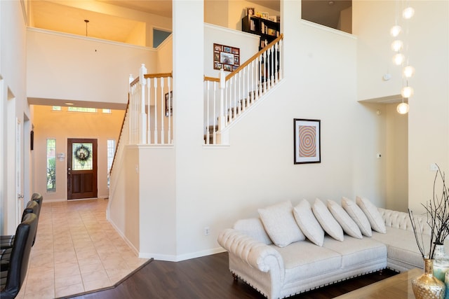interior space featuring baseboards and a towering ceiling