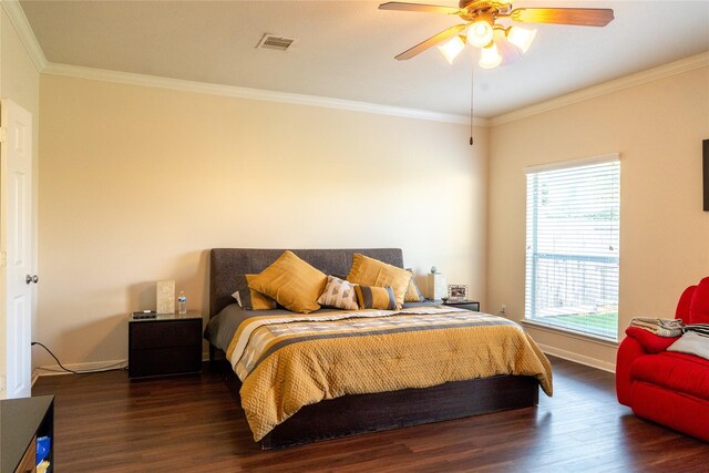 bedroom featuring ceiling fan, visible vents, wood finished floors, baseboards, and ornamental molding