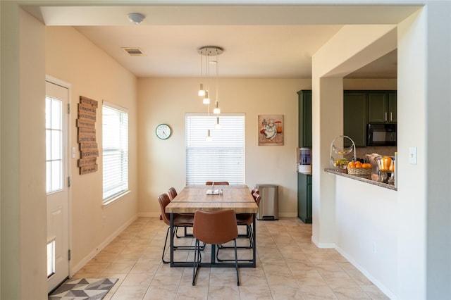 dining space featuring baseboards and visible vents
