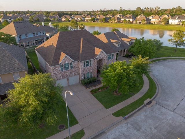 bird's eye view with a water view and a residential view