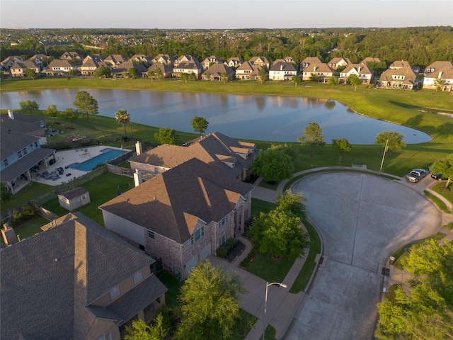 bird's eye view featuring a water view and a residential view