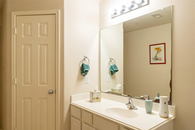 bathroom with vanity and visible vents
