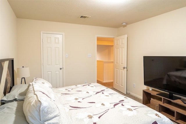 bedroom featuring baseboards, carpet flooring, and visible vents