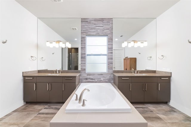 full bath with two vanities and a sink
