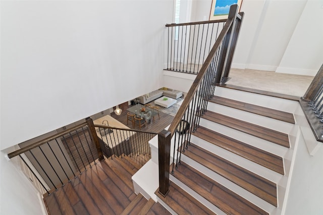stairs featuring wood finished floors