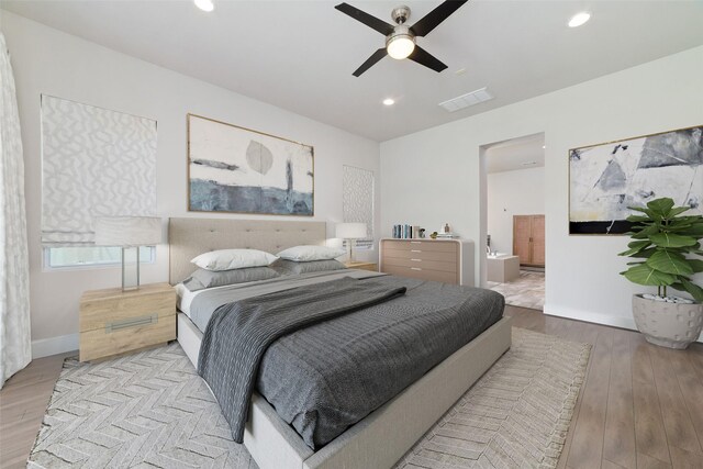 bedroom with visible vents, wood finished floors, recessed lighting, baseboards, and ensuite bath