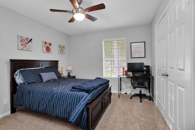carpeted bedroom with baseboards, ceiling fan, and a closet