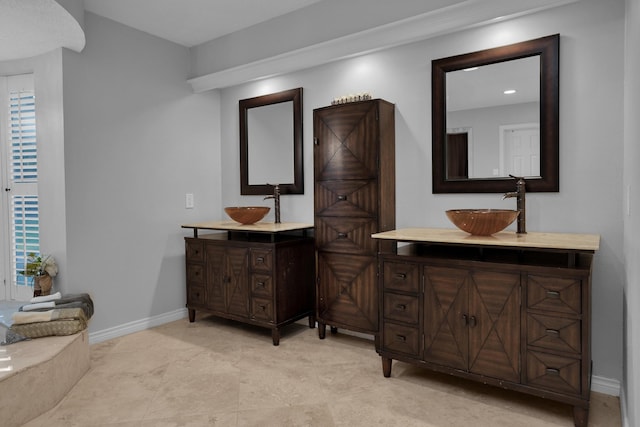 full bathroom featuring baseboards and vanity
