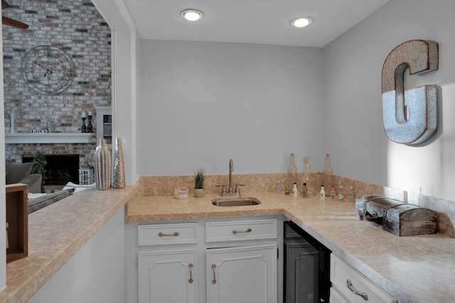 interior space with beverage cooler, a fireplace, and vanity