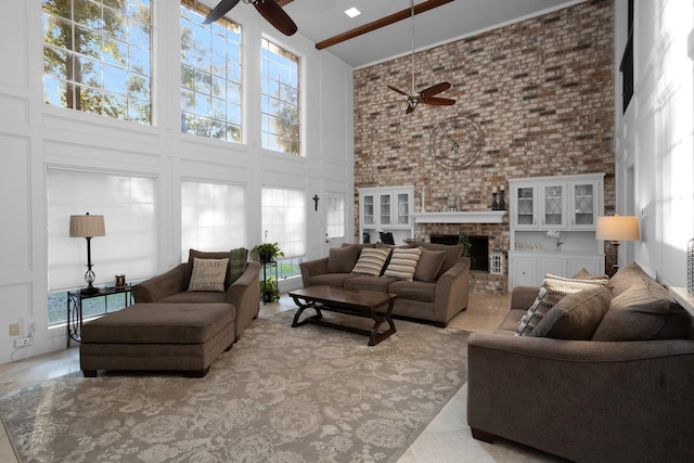 tiled living room featuring plenty of natural light, a high ceiling, and ceiling fan