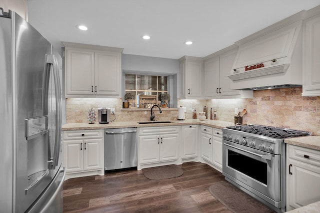 kitchen featuring appliances with stainless steel finishes, a sink, dark wood-type flooring, backsplash, and custom exhaust hood